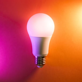 Vibrant LED lightbulb on a colorful gradient background, symbolizing energy efficiency and creativity.